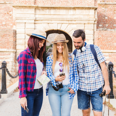 A group of tourists standing outside an Indian monument