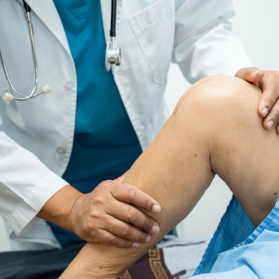 Doctor examining a patient's knee after surgery