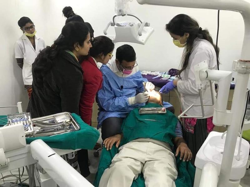 dr kapil performing dental procedure of a patient