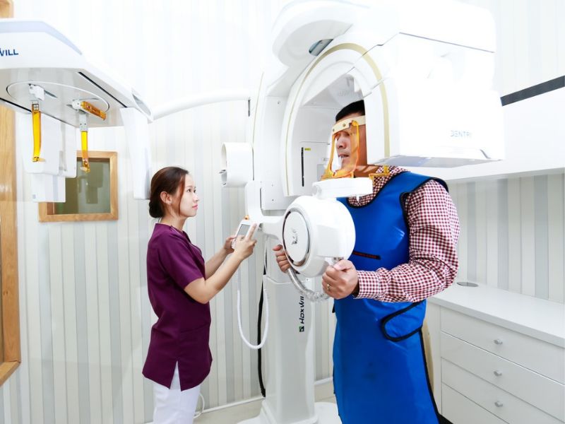 A dental technician taking an OPG of a patient