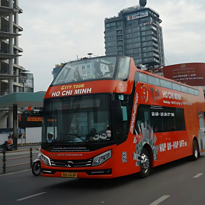 A red city tour bus on the roads of Ho Chi Minh City, Vietnam