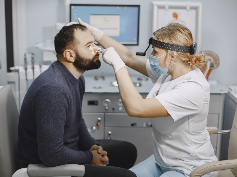 A doctor visualizing nose of patient through endoscopy process