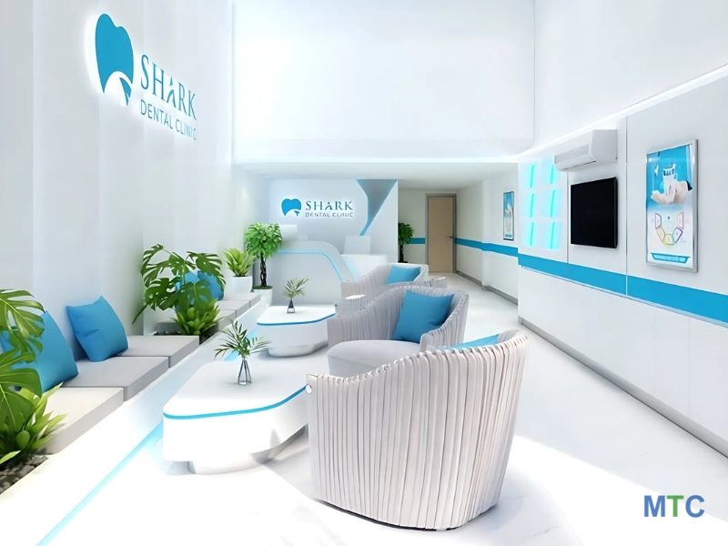 Bright and modern waiting area with a sleek white and blue design, comfortable seating, and green plants at Shark dental clinic, Ho Chi Minh City