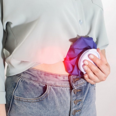 Image of a person applying cold pack for pain relief as part of aftercare of tummy tuck